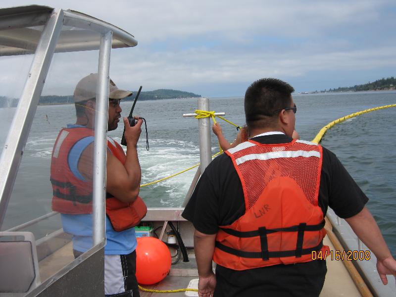 Frank Lawrence III and Victor Johnson conducting an oil spill boom deployment exercise