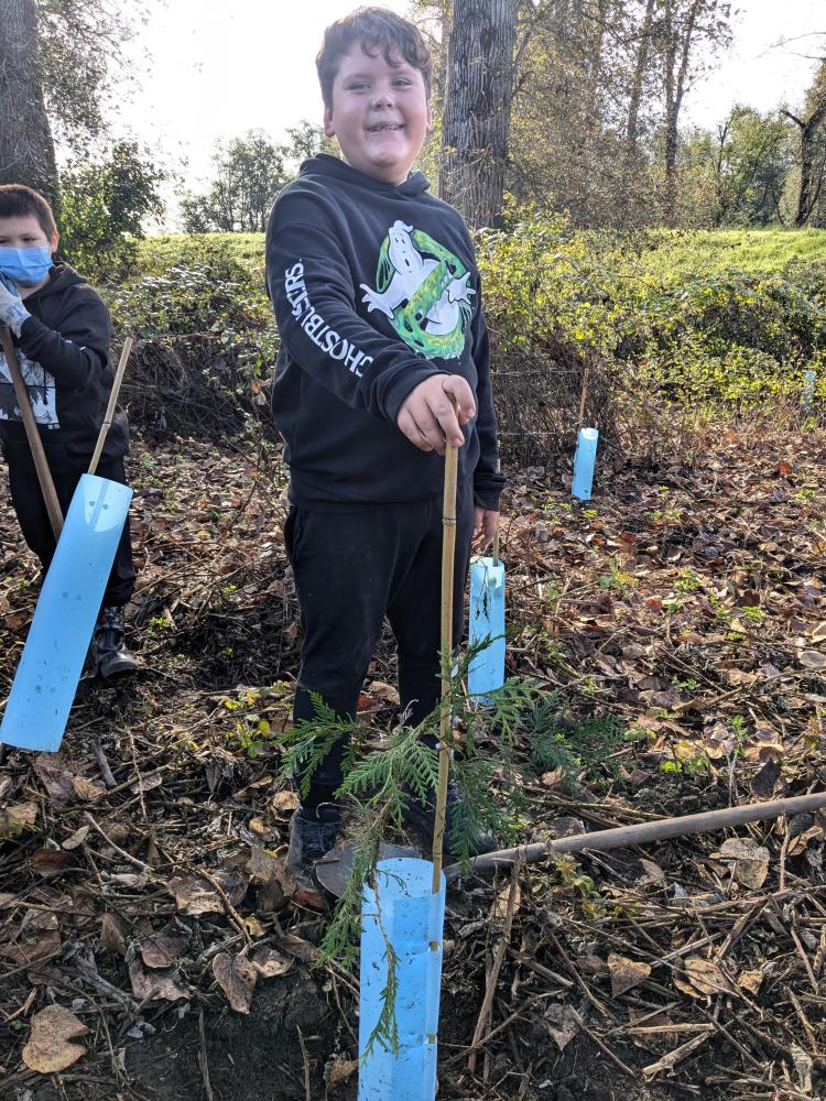 Lummi youth planting trees along the Nooksack for salmon habitat.